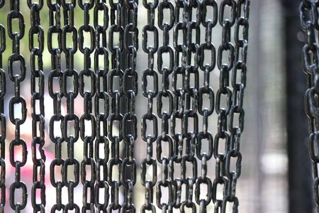 Metallic chain hanging like wall which is black in colorの写真素材