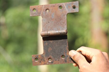 Hinges used in supporting doors to open and close hand heldの写真素材