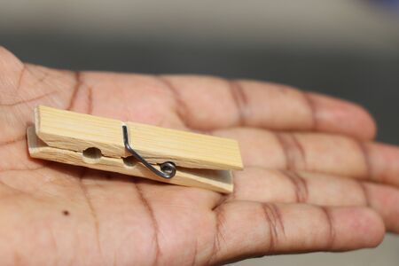 Wooden cloth hanging clip with steel spring on handの写真素材