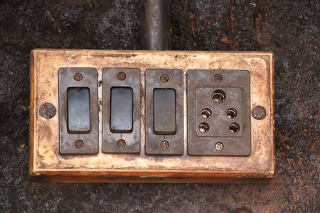Switch box or plug box fixed to wall which looks very oldの写真素材