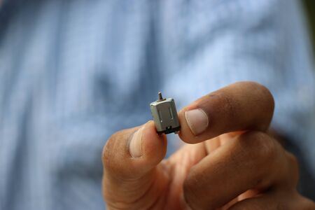 Mini dc motor held in handの写真素材