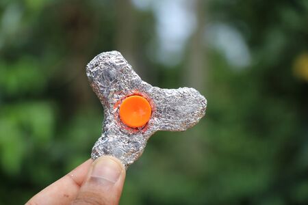 Silver Color fidget spinner held in handの写真素材