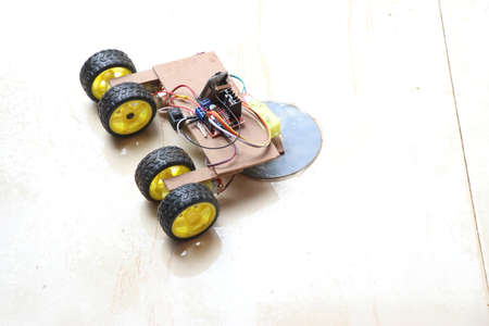 Floor cleaning robot which is controlled by smartphone which is having wheels and a mop at the front which spinsの写真素材