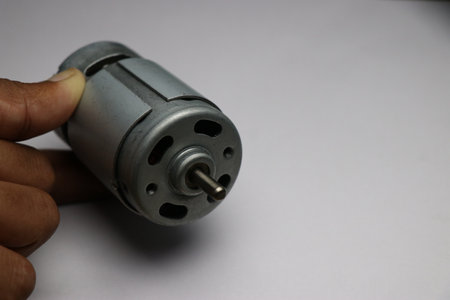 DC Motor also called by name 775 Motor used in cutter, electric drill and CNC Projects. Hand holding 12v DC Motorの写真素材