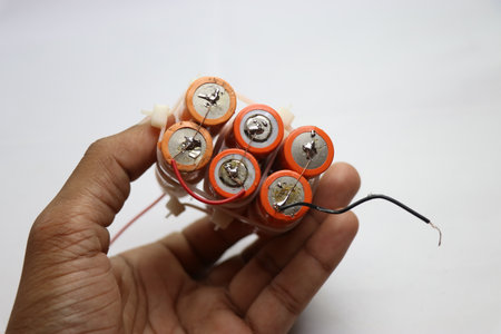 Battery pack made from soldering lithium ion batteries held in hand. Rechargeable batteries which is...