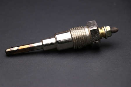 Glow plugs for diesel engine on dark background. Glow plug which is spare part for automobiles. Single type glow plugの写真素材