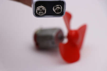 Battery used to power small electric motor showing DIY project ideaの写真素材