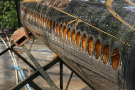 Solar water heater with removed solar collector. Solar water heater with vacuum tubes removed for maintenanceの写真素材