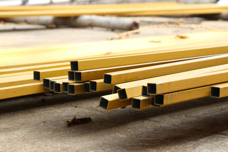 Stainless steel square metal tube painted with yellow used for constructionの写真素材