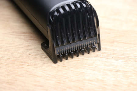 Beard trimmer with closeup of clip part on wooden backgroundの写真素材