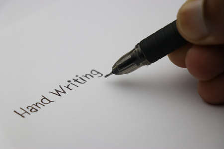 Hand writing being written on plane sheet of paper by black pen, Concept showing fonts of...