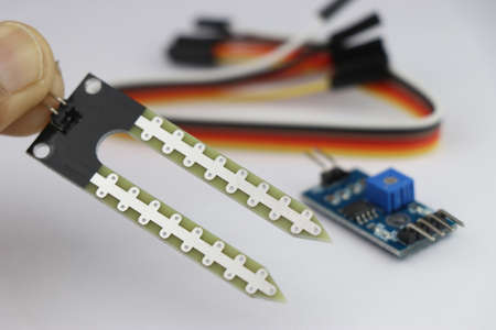 Soil moisture sensor module held in hand, Soil humidity sensor or hygrometer for electronic projects