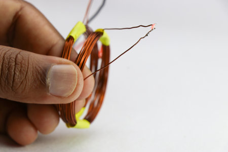 Prototype of wireless electricity transmission project held in hand on a white background