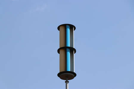 Vertical axis wind turbine or VAWT with blue sky in the background