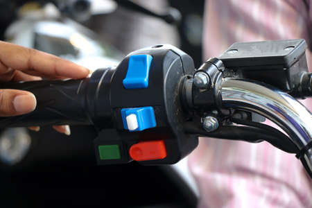 Different type of control switches on a bike handle or handlebar with hands touching themの写真素材