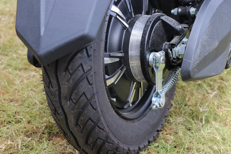 Rubber wheels connected to a brushless motor on an electric vehicle with rear view of vehicle...