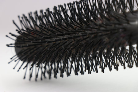 Bristles of a used comb close-up or in other words hairbrush on a white background
