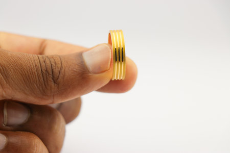 Gold ring held in the hand. Beautiful wedding ring made from gold