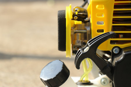 Brush cutter machine with cord to start the brush cutter along with the view of gasoline tank and carburetor. Equipment used in gardeningの写真素材
