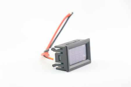 Voltmeter and ammeter on a small board that shows the values of current and voltage isolated on...