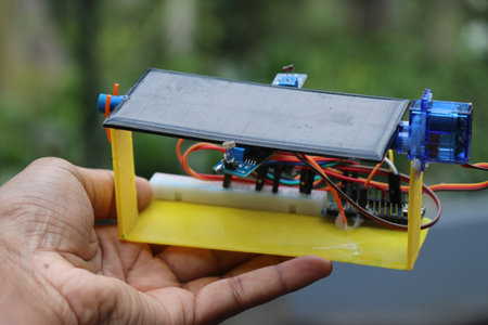 Simple solar tracker prototype build using light dependent resistors and 3d printed parts held in...