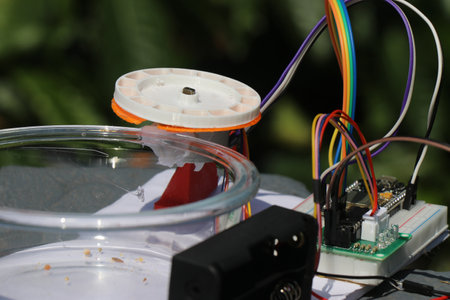 Stepper motor shaft connected to a 3d printed food dispenser along with motor driver and battery holderの写真素材