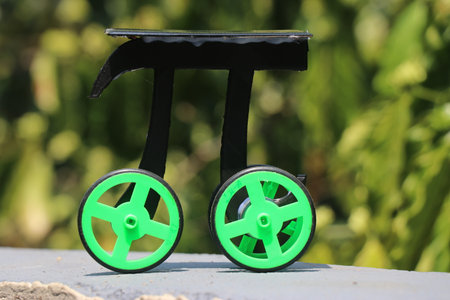 Solar powered car built at home with 3d printed parts and solar panel on natural outdoors