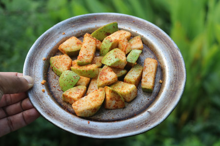 Plate of spiced guava pieces ready to eat. Salt and chili powdered guava fruit ready to be served on a plateの写真素材