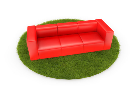 Red sofa on green field. Isolated on whiteの写真素材