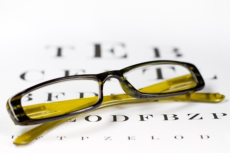 glasses on the background of eye test chart の写真素材