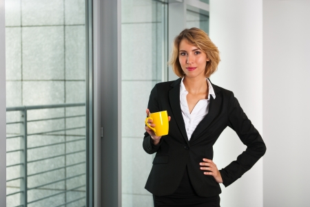 Business woman holding coffee cupの写真素材
