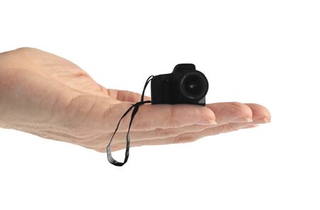 Hand holding a tiny camera isolated on whiteの写真素材