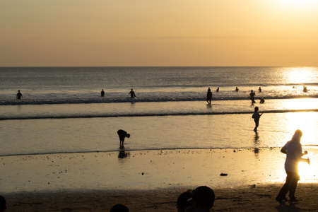 Sunset landscape at the beach with some peopleの写真素材