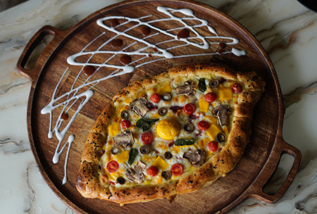 Pizza with various types of toppings on a wooden board.の写真素材