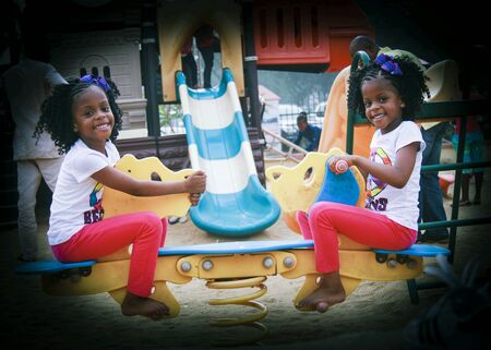 Twin girls at playgroundの素材