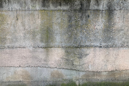 Texture of old rustic concrete wall covered with gray stuccoの写真素材