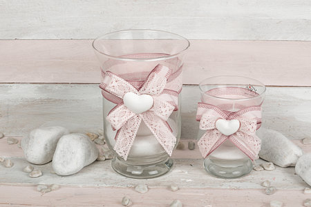 Valentine's Day background with hearts in glass and white stones. Colored and scented candle on wooden background. ideal gift for Christmas, Easter, Valentine's Dayの写真素材