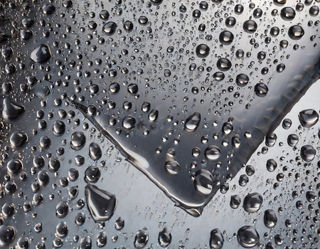 Water drops on a metal surface as a background. Macro shot.の素材