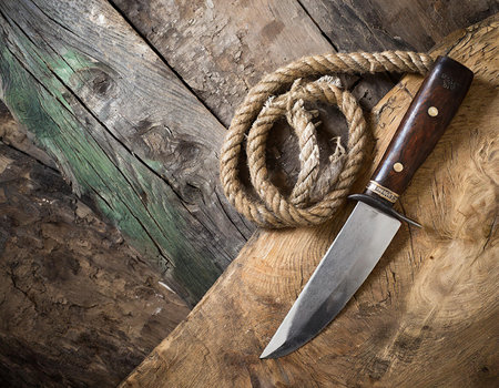Knife and rope on a wooden background. View from above.の素材