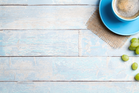 coffee cup with grapes and a wooden backgroundの写真素材