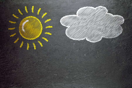 sun and a cloud on a blackboardの写真素材