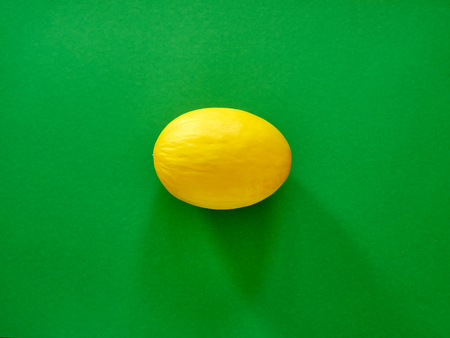 Yellow Melon Fruit isolated in green background viewed from above - flatlay look - Image Minimalism conceptの写真素材