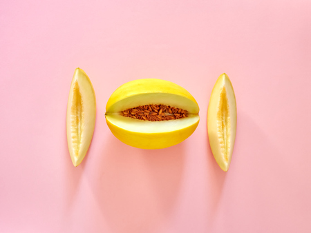 Yellow Melon Fruit isolated in pink background viewed from above - flatlay look - Image Minimalism conceptの写真素材