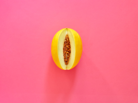 Yellow Melon Fruit isolated in fucsia background viewed from above - flatlay look - Image Minimalism conceptの写真素材