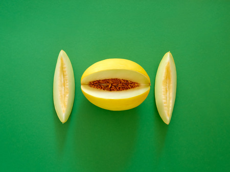 Yellow Melon Fruit isolated in green background viewed from above - flatlay look - Image Minimalism conceptの写真素材