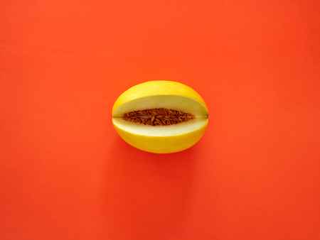 Yellow Melon Fruit isolated in orange background viewed from above - flatlay look - Image Minimalism conceptの写真素材