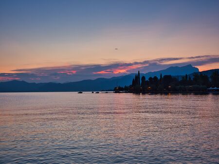Spectacular sunset view from the village of Bardolino on the shores of Lake Gardaの写真素材