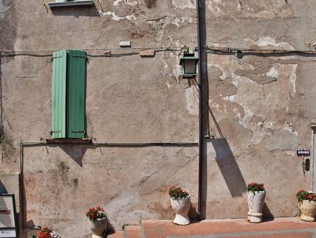 Lovely scene of rustic wall, window, flowers in vases and lantern of the village of Sirmione on the shores of Lake Gardaのeditorial素材