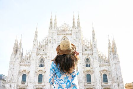 Travelver with a hat looking the front of Milan Duomo in Italy during the dayの写真素材