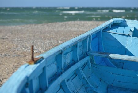 A blue boat on the beach of the North Seaの写真素材